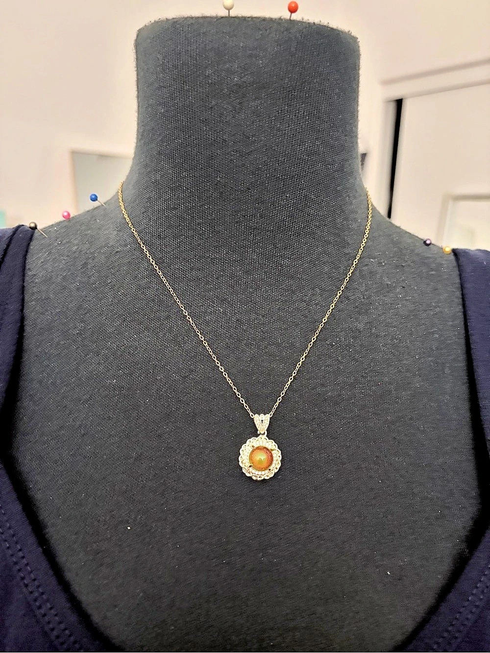 Gold chain with a color changing pendant necklace